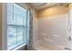 Bright shower area with a white shower curtain, window with blinds, and shower head at 319 Brinkley Cir, Mebane, NC 27302