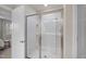 Clean, modern bathroom featuring a glass-enclosed shower with metal trim and tiled walls at 3408 Dropseed Dr, Apex, NC 27502
