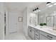 Modern bathroom with double vanity, gray cabinets, and white marble tile floor at 3408 Dropseed Dr, Apex, NC 27502
