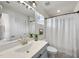 Well-lit bathroom featuring a grey vanity, a modern sink, and a shower with a curtain at 3408 Dropseed Dr, Apex, NC 27502
