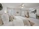 Light-filled main bedroom features neutral decor, large windows, and television at 3408 Dropseed Dr, Apex, NC 27502