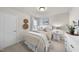 Cozy bedroom with neutral tones, a comfortable bed, soft textures, and a decorative plant on a dresser at 3408 Dropseed Dr, Apex, NC 27502