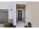 Close-up of the front door with address, complemented by stone accents and a welcoming light fixture at 3408 Dropseed Dr, Apex, NC 27502