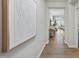 Bright hallway with hardwood flooring, leading into an open living and dining area at 3408 Dropseed Dr, Apex, NC 27502