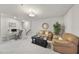 Cozy finished basement featuring neutral carpet, tan sofas, a dark wood coffee table, and a small work station at 3408 Dropseed Dr, Apex, NC 27502
