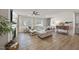 Open-concept living room with fireplace, comfortable seating, and large windows at 3408 Dropseed Dr, Apex, NC 27502