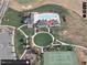 Aerial view showcasing the community pool, clubhouse, tennis court, and well-manicured landscaping at 363 Rolling Meadows Ln, Chapel Hill, NC 27517