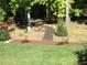 Beautifully landscaped backyard featuring a charming pathway and lush greenery at 363 Rolling Meadows Ln, Chapel Hill, NC 27517