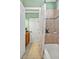 Bathroom featuring a combined tub and shower with tiled surround and a convenient built-in shelf at 363 Rolling Meadows Ln, Chapel Hill, NC 27517