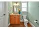 Well-lit bathroom with a wooden vanity, granite countertop, and a classic white toilet at 363 Rolling Meadows Ln, Chapel Hill, NC 27517