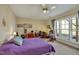 Bedroom boasts a ceiling fan, carpet flooring, natural light, and a workspace for comfortable living at 363 Rolling Meadows Ln, Chapel Hill, NC 27517