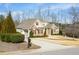 A large house with stone facade, red shutters, and a large lawn area at 363 Rolling Meadows Ln, Chapel Hill, NC 27517