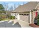 Side view of a tan siding home with a brown roof and a two car garage at 363 Rolling Meadows Ln, Chapel Hill, NC 27517