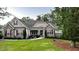 Well-maintained home featuring a stone facade, red shutters, and a lush green lawn at 363 Rolling Meadows Ln, Chapel Hill, NC 27517