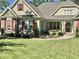 Charming home featuring a well-manicured lawn, stone accents, and inviting front porch at 363 Rolling Meadows Ln, Chapel Hill, NC 27517