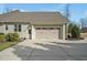 Attached two car garage of a tan siding home with a brown roof at 363 Rolling Meadows Ln, Chapel Hill, NC 27517