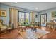 Sunlit living room with hardwood floors, large window, and eclectic mix of furniture at 363 Rolling Meadows Ln, Chapel Hill, NC 27517