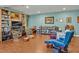 Bright living room featuring hardwood floors, bookshelves, comfortable armchairs, and ample natural light at 363 Rolling Meadows Ln, Chapel Hill, NC 27517