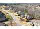 A street view of several homes in a quiet neighborhood with beautiful landscaping and mature trees at 363 Rolling Meadows Ln, Chapel Hill, NC 27517
