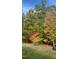 A vibrant view of trees with green, orange, and red leaves, suggesting fall foliage at 363 Rolling Meadows Ln, Chapel Hill, NC 27517