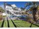 Backyard oasis with pool, putting green, outdoor seating, and lush landscaping at 3633 Jordan Shires Dr, New Hill, NC 27562