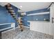 Stylish basement features unique stairs, bright blue walls, and patterned tile flooring at 3633 Jordan Shires Dr, New Hill, NC 27562