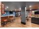 Entertainment-ready basement area with wet bar, sports decor, and open sightlines to the game and living room at 3633 Jordan Shires Dr, New Hill, NC 27562