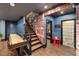 Basement recreation room with a brick accent wall, staircase, and adjacent bathroom and fitness area at 3633 Jordan Shires Dr, New Hill, NC 27562