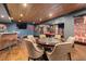 Basement poker table area with a view to the pool table, bar, and an open entertainment space at 3633 Jordan Shires Dr, New Hill, NC 27562