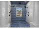 Stunning walk-in shower with dual shower heads and designer blue and white tile surround at 3633 Jordan Shires Dr, New Hill, NC 27562
