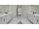 Bathroom featuring double vanity, modern fixtures, white cabinets and gray walls at 3633 Jordan Shires Dr, New Hill, NC 27562