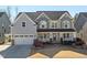 Charming two-story home with a well-manicured front yard and attached garage at 3633 Jordan Shires Dr, New Hill, NC 27562
