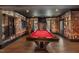 Basement game room featuring a red pool table, brick accent wall, and stylish decor at 3633 Jordan Shires Dr, New Hill, NC 27562