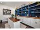 Well-organized home office featuring blue built-in shelving, ample storage, and a comfortable workspace at 3633 Jordan Shires Dr, New Hill, NC 27562