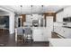 Open-concept kitchen featuring white cabinetry, a large island, and modern pendant lighting at 3633 Jordan Shires Dr, New Hill, NC 27562