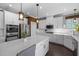 Well-lit kitchen boasts a large island, stainless steel appliances, and white cabinetry at 3633 Jordan Shires Dr, New Hill, NC 27562