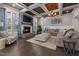 Elegant living room with a stone fireplace, coffered ceiling, and modern furniture at 3633 Jordan Shires Dr, New Hill, NC 27562
