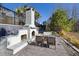 Backyard boasts an outdoor fireplace with seating and wooded views at 3633 Jordan Shires Dr, New Hill, NC 27562