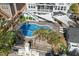 Aerial view of a large pool with palm trees, sunshades, and a covered patio at 3633 Jordan Shires Dr, New Hill, NC 27562