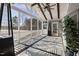 Screened in porch featuring a vaulted ceiling, ceiling fan, and patterned area rug at 3633 Jordan Shires Dr, New Hill, NC 27562