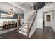 Elegant staircase with wooden railings and decorative runner, adjacent to a dining room with wainscoting at 3633 Jordan Shires Dr, New Hill, NC 27562