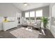 Bright sun room with large windows, comfortable seating, and hardwood floors at 3633 Jordan Shires Dr, New Hill, NC 27562