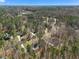 A high angle view of a home surrounded by lush forest, emphasizing a sense of privacy and natural beauty at 3659 Brooks Bnd, Franklinton, NC 27525