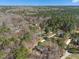 Expansive aerial view of a wooded community with homes nestled amongst the trees at 3659 Brooks Bnd, Franklinton, NC 27525
