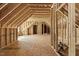 Unfinished attic space with exposed wood beams, offering potential for customization at 3659 Brooks Bnd, Franklinton, NC 27525