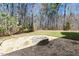 Picturesque backyard featuring a stone fire pit, providing an inviting outdoor space at 3659 Brooks Bnd, Franklinton, NC 27525