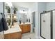 Bright bathroom featuring double sink vanity, walk-in shower with glass door, and tile flooring at 3659 Brooks Bnd, Franklinton, NC 27525