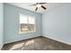 Carpeted bedroom featuring neutral carpet and trim, bright windows, and ceiling fan at 3659 Brooks Bnd, Franklinton, NC 27525