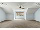 Large bonus room with sloped ceilings, neutral carpeting, and a ceiling fan at 3659 Brooks Bnd, Franklinton, NC 27525