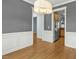 Elegant dining room with hardwood floors, wainscoting, and views of the kitchen at 3659 Brooks Bnd, Franklinton, NC 27525